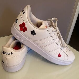 Adidas, women’s white sneaker with flowers.